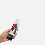Hand holding a RACE+ energy gel