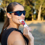 Runner taking a RocketFuel RACE+ gel outdoors